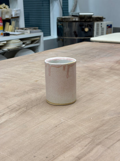 Ceramic cup with a drippy matte pink exterior and glossy white interior. Stamped with LKBK maker’s mark.