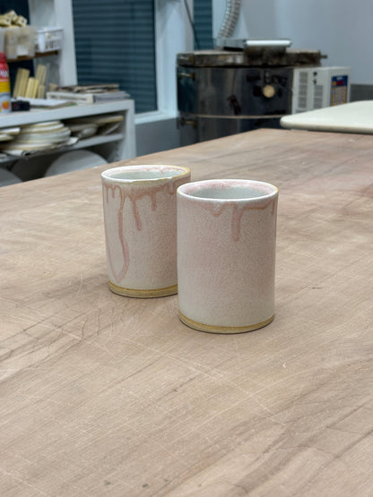 Ceramic cup with a drippy matte pink exterior and glossy white interior. Stamped with LKBK maker’s mark.