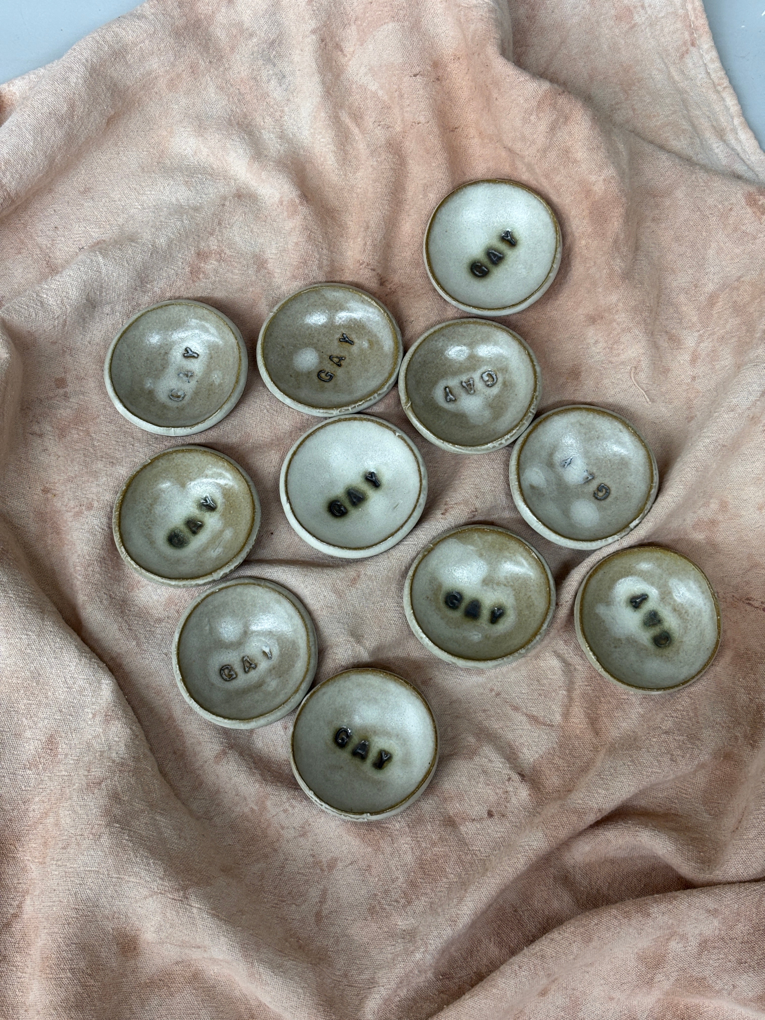Collection of small ceramic dishes with GAY stamped in the middle, highlighted in green copper. Stamped with LKBK maker’s mark.